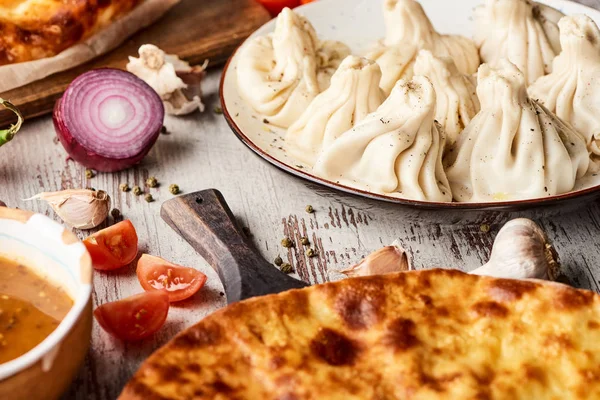 Selective focus of Imeretian khachapuri, kharcho and khinkali on wooden table — Stock Image Selective Focus Imeretian Khachapuri Kharcho Khinkali Wooden Table Stock Image