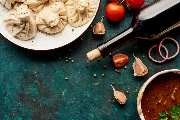Top view of delicious khinkali, bottle of wine, kharcho on green background — Stock Image Top View Delicious Khinkali Bottle Wine Kharcho Green Background Stock Image