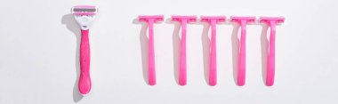 top view of female pink razors on white background, panoramic shot clipart
