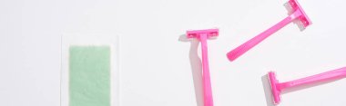 top view of female pink razors and depilation stripe on white background, panoramic shot clipart