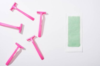 top view of female pink razors and depilation stripe on white background clipart