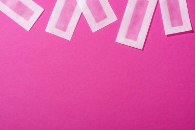 top view of wax depilation stripes on pink background clipart