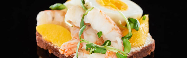 panoramic shot of tasty shrimps on smorrebrod sandwich on black 