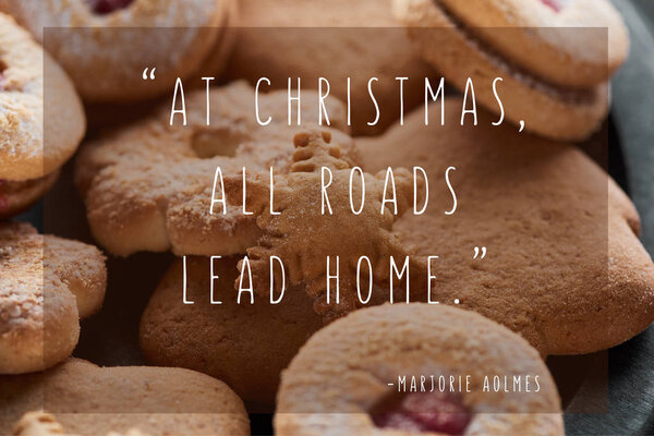 close up view of delicious baked snowflake cookie with at Christmas all roads lead home quote