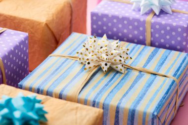 selective focus of stripped present near colorful gifts  clipart