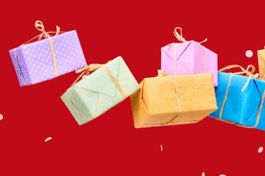 confetti near colorful gift boxes on red  clipart