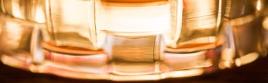 Close up view of brandy in textured glass, panoramic shot clipart