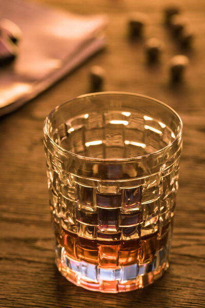Selective focus of glass of brandy on wooden table