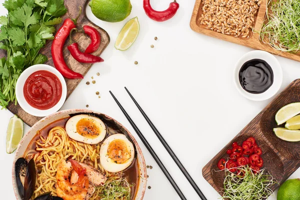 Top view of spicy seafood ramen near fresh ingredients and chopsticks on white surface — Stock Image Top View Spicy Seafood Ramen Fresh Ingredients Chopsticks White Surface Royalty Free Stock Photos