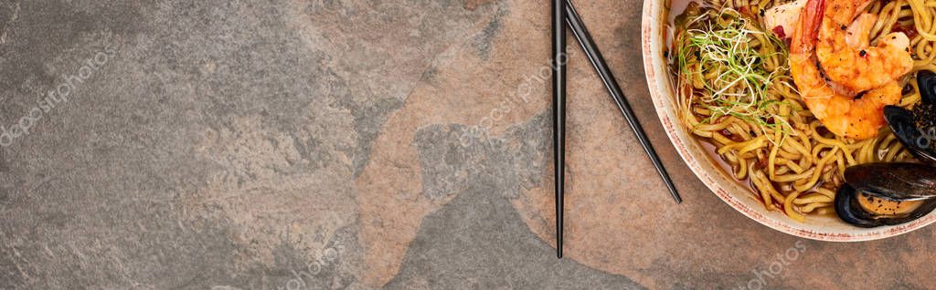 Top view of spicy seafood ramen with chopsticks on stone surface, panoramic shot — Stock Image Top View Spicy Seafood Ramen Chopsticks Stone Surface Panoramic Shot Royalty Free Stock Photos