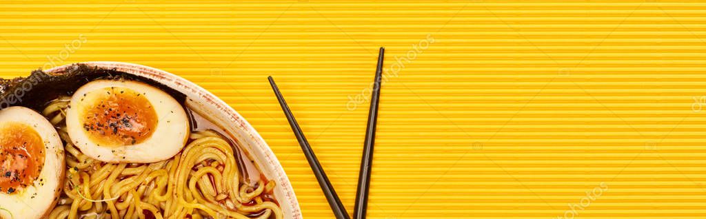 Top view of seafood ramen near chopsticks on yellow surface, panoramic shot — Stock Image Top View Seafood Ramen Chopsticks Yellow Surface Panoramic Shot Royalty Free Stock Photos