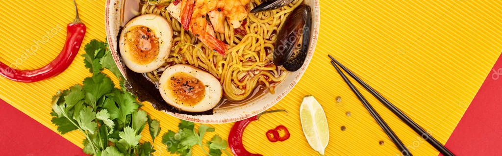 Top view of seafood ramen near fresh ingredients and chopsticks on yellow and red surface, panoramic shot — Stock Image Top View Seafood Ramen Fresh Ingredients Chopsticks Yellow Red Surface Stock Image