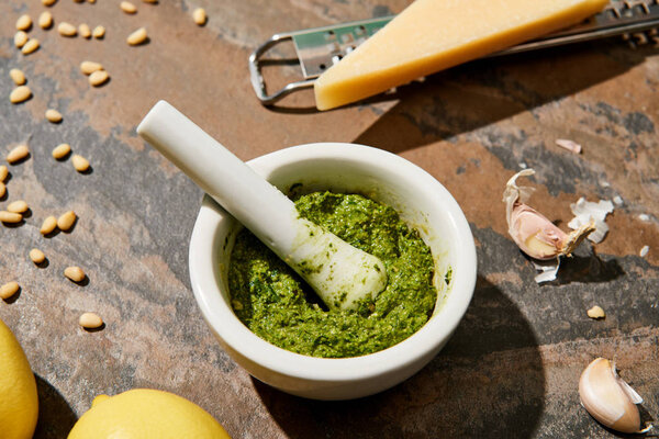 pesto sauce and ingredients on stone surface