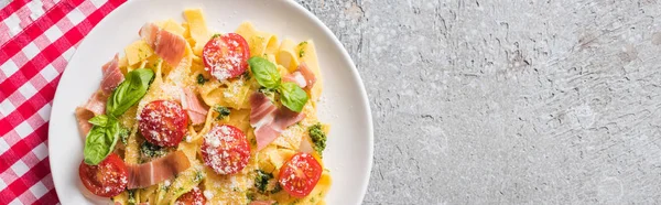 Top View Cooked Pappardelle Tomatoes Basil Prosciutto Plaid Napkin Grey — Stock Photo, Image