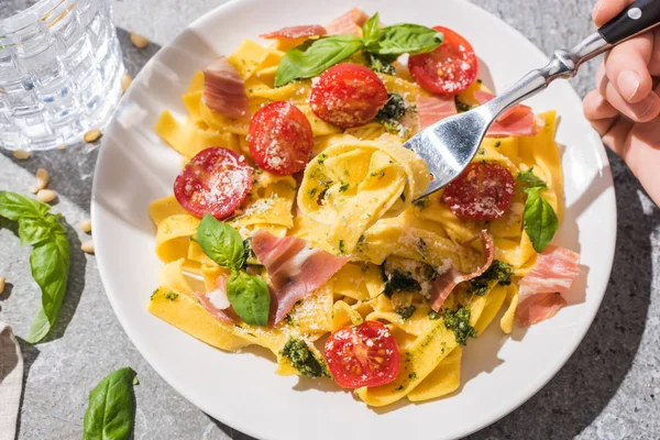 Partial View Woman Eating Tasty Pappardelle Tomatoes Pesto Prosciutto Water — Stock Photo, Image