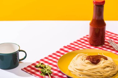 Prepared spaghetti with tomato sauce beside cup on white surface on yellow background clipart