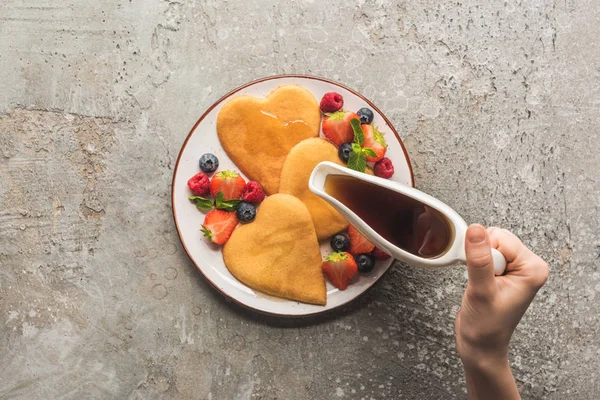 Cropped View Woman Adding Maple Syrup Heart Shaped Pancakes Berries — Stock Photo, Image