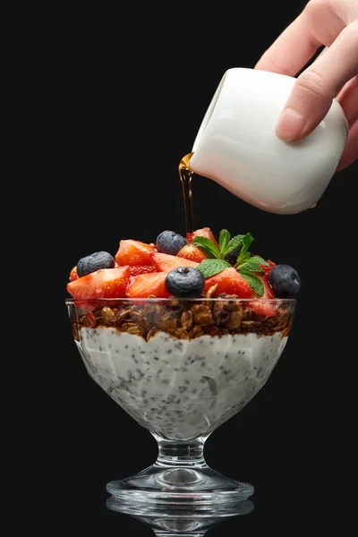 Cropped View Woman Adding Syrup Fresh Granola Berries Chia Seeds — Stock Photo, Image