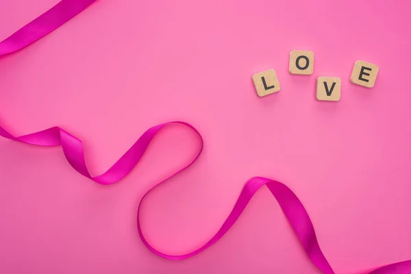 Top View Silk Curved Ribbon Wooden Blocks Love Lettering Isolated — Stock Photo, Image