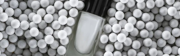 Top View White Nail Polish Bottle Grey Decorative Beads Panoramic — Stock Photo, Image