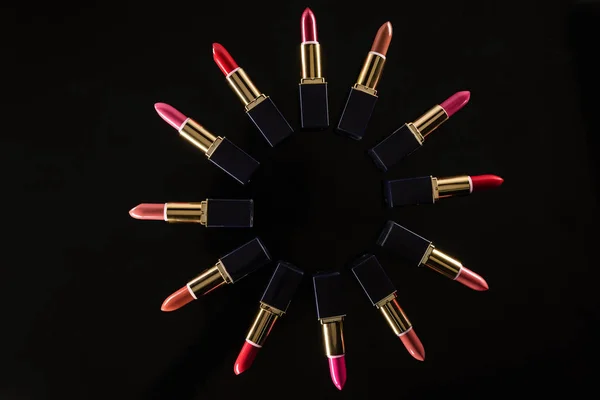 Top view of assorted lipsticks in luxury tubes arranged in circle isolated on black — Stock Image Top View Assorted Lipsticks Luxury Tubes Arranged Circle Isolated Black Royalty Free Stock Photos