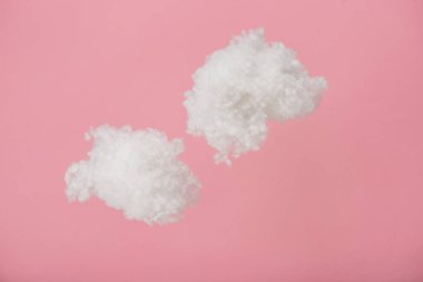 white fluffy clouds made of cotton wool isolated on pink clipart