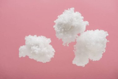 white fluffy clouds made of cotton wool isolated on pink clipart