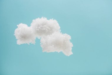 white fluffy clouds made of cotton wool isolated on blue background clipart