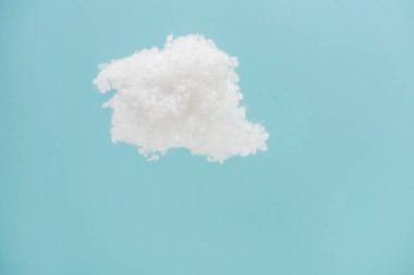 white fluffy cloud made of cotton wool isolated on blue background clipart