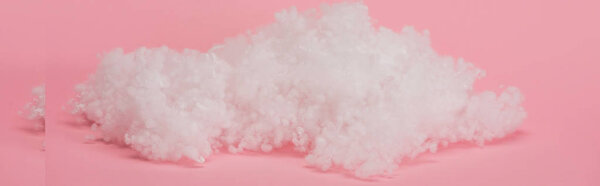 white fluffy cloud made of cotton wool on pink background, panoramic shot