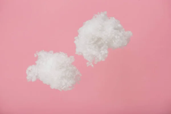 ピンクに隔離されたコットンウールで作られた白いふわふわの雲 — ストック写真