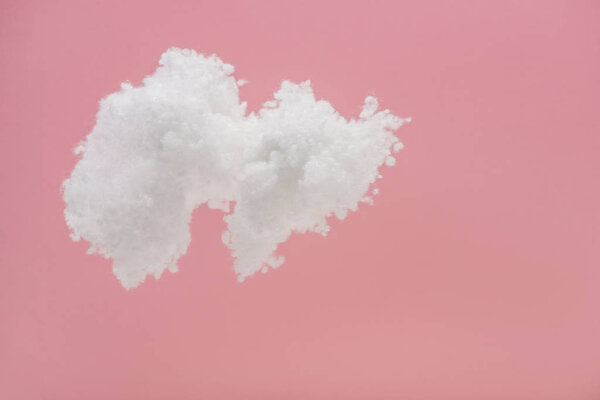 white fluffy cloud made of cotton wool isolated on pink