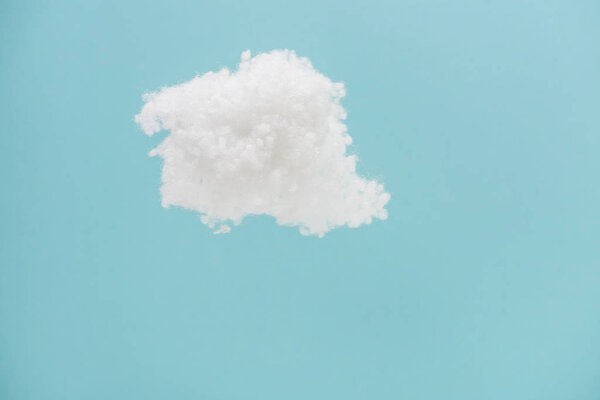 white fluffy cloud made of cotton wool isolated on blue background