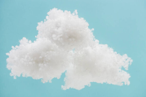 white fluffy cloud made of cotton wool isolated on blue background