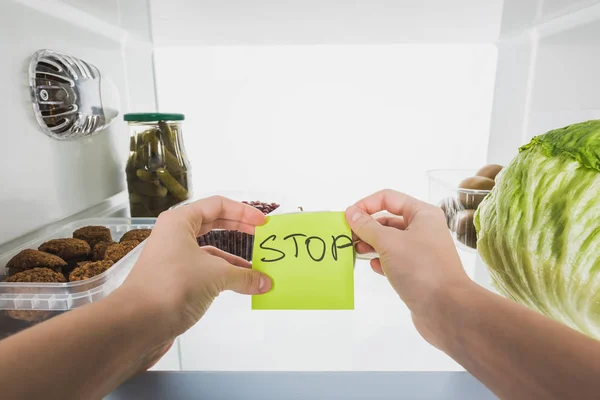Cropped View Woman Holding Card Stop Lettering Food Fridge Background — 스톡 사진