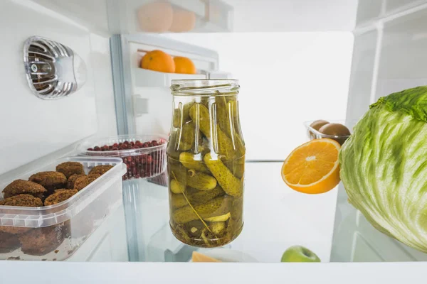 Jar of pickles with cabbage, fruits and cutlets in refrigerator with open door isolated on white — Stock Image Jar Pickles Cabbage Fruits Cutlets Refrigerator Open Door Isolated White Royalty Free Stock Images