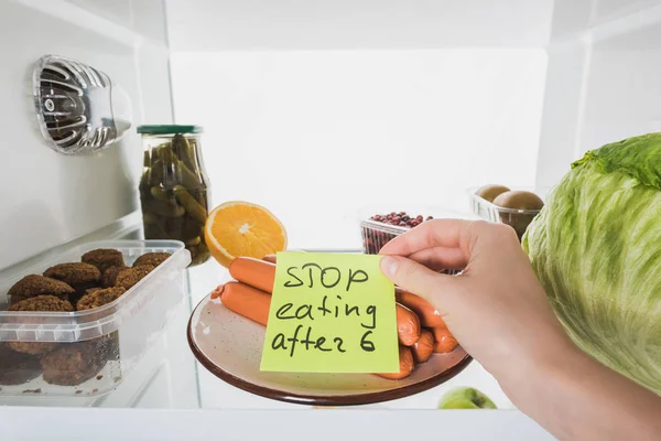 Cropped view of woman with stop eating after six lettering on card with food in fridge isolated on white — Stock Image Cropped View Woman Stop Eating Six Lettering Card Food Fridge Royalty Free Stock Photos