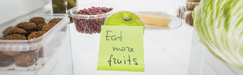 Panoramic shot of card with eat more fruits lettering in fridge with food isolated on white — Stock Image Panoramic Shot Card Eat More Fruits Lettering Fridge Food Isolated Stock Picture
