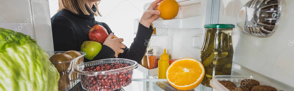 Cropped view of girl taking fresh fruits from refrigerator isolated on white, panoramic shot — Stock Image Cropped View Girl Taking Fresh Fruits Refrigerator Isolated White Panoramic Stock Photo