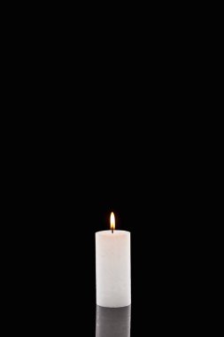burning white candle glowing isolated on black clipart