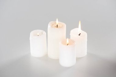 burning candles glowing on white background with shadow clipart