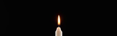 burning white candle glowing isolated on black, panoramic shot clipart