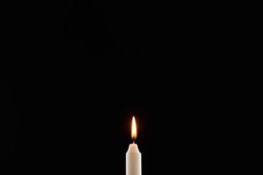 burning white candle glowing isolated on black clipart