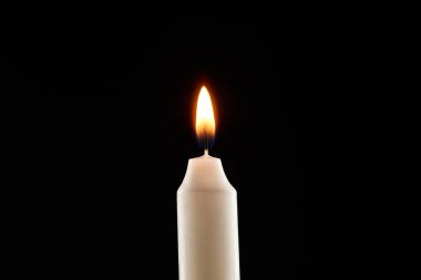 burning white candle glowing isolated on black clipart