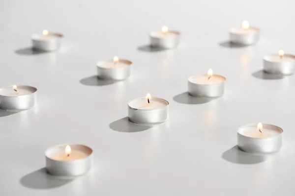 Selective Focus Burning Candles Glowing White Surface — Stock Photo, Image