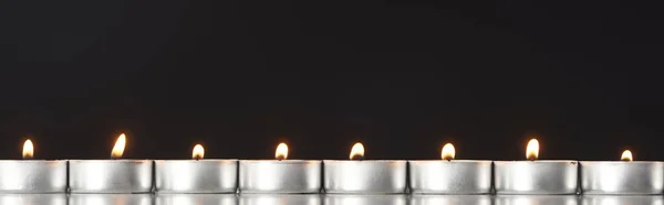 Burning Candles Arranged Line Glowing Isolated Black Panoramic Shot — Stock Photo, Image