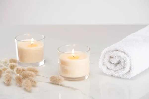 Fluffy Bunny Tail Grass Burning White Candles Glass Rolled Towel — Stock Photo, Image