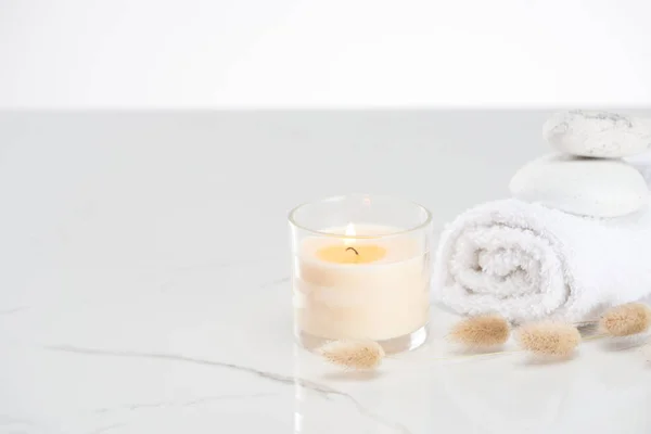 Fluffy Bunny Tail Grass Burning White Candle Glass Rolled Towel — Stock Photo, Image