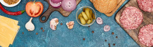 вид сверху на свежие ингредиенты бургера на голубой текстурированной поверхности, панорамный снимок
