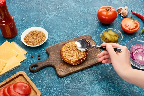 Cropped View Woman Cooking Delicious Fresh Burger Mustard Blue Textured — 스톡 사진